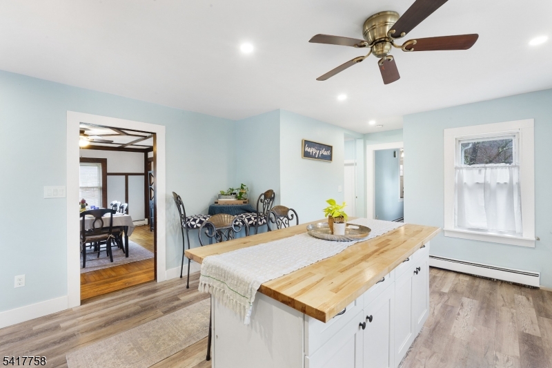322 Berkshire Valley Road Wharton, NJ 07885 - Photo 7 of 30 a view of a dining room with furniture and a chandelier