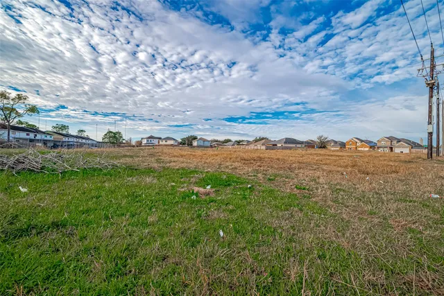 a view of dirt road with a building in the background