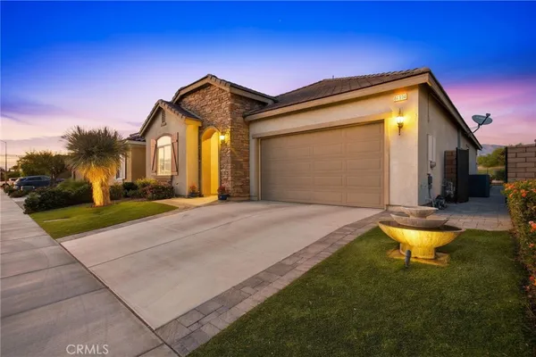a front view of a house with yard and garage