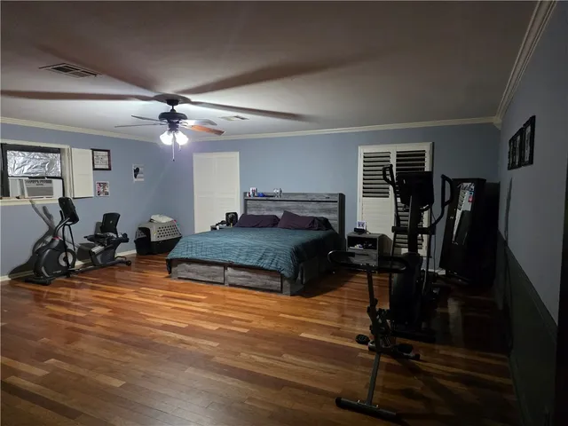 a living room with furniture a window and gym equipment