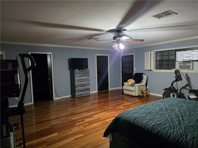 a spacious bedroom with a bed and a chandelier