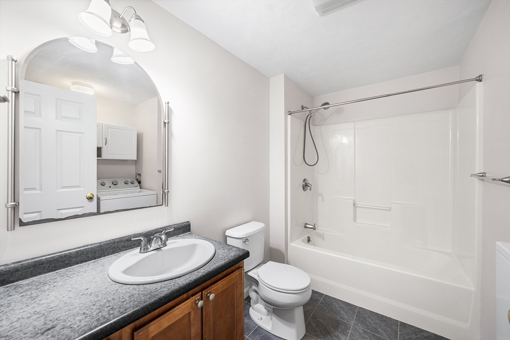41 Boston Road, Unit 234 Billerica, MA 01862 - Photo 8 of 18 a bathroom with a granite countertop sink toilet a shower and a mirror