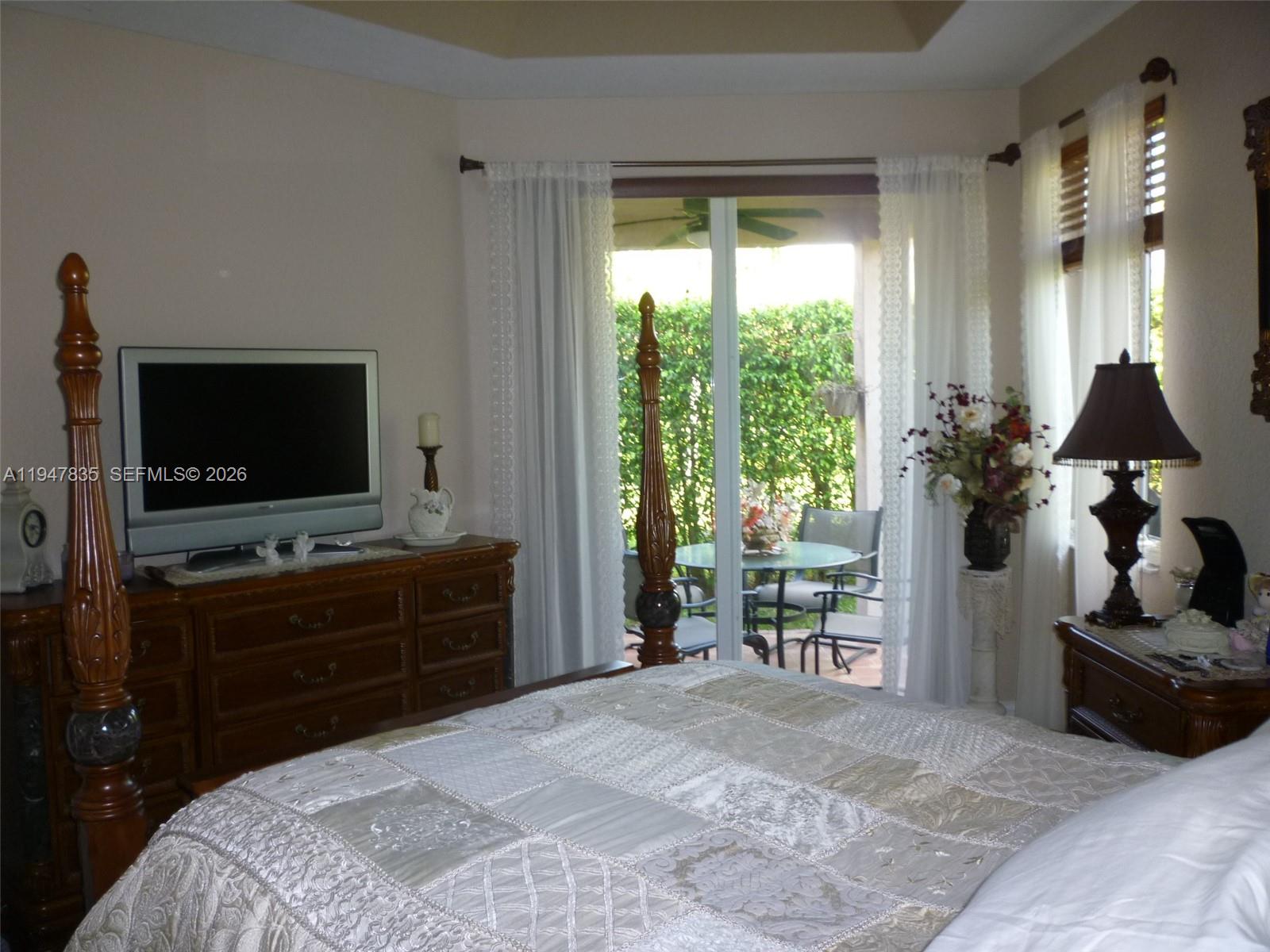 644 Conservation Drive Weston, FL 33327 - Photo 14 of 24 a bedroom with a bed and a flat tv screen