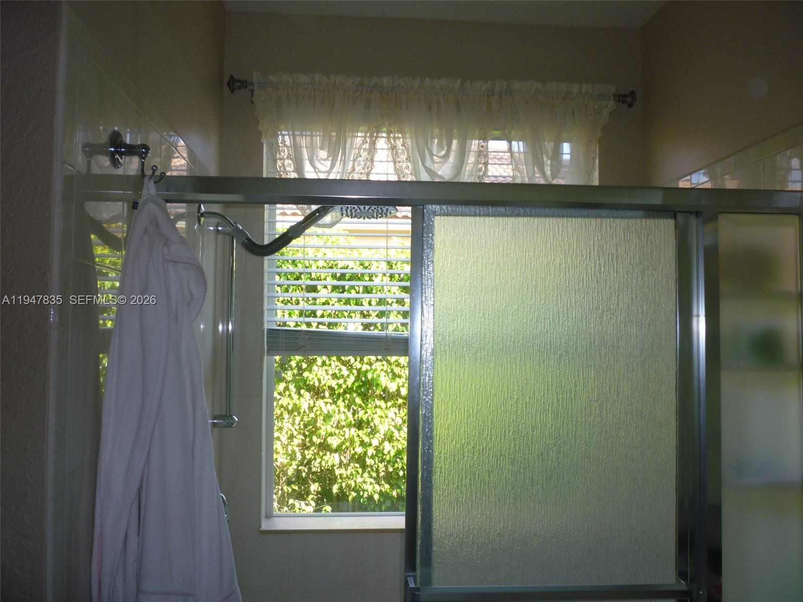 644 Conservation Drive Weston, FL 33327 - Photo 16 of 24 a bathroom with a window
