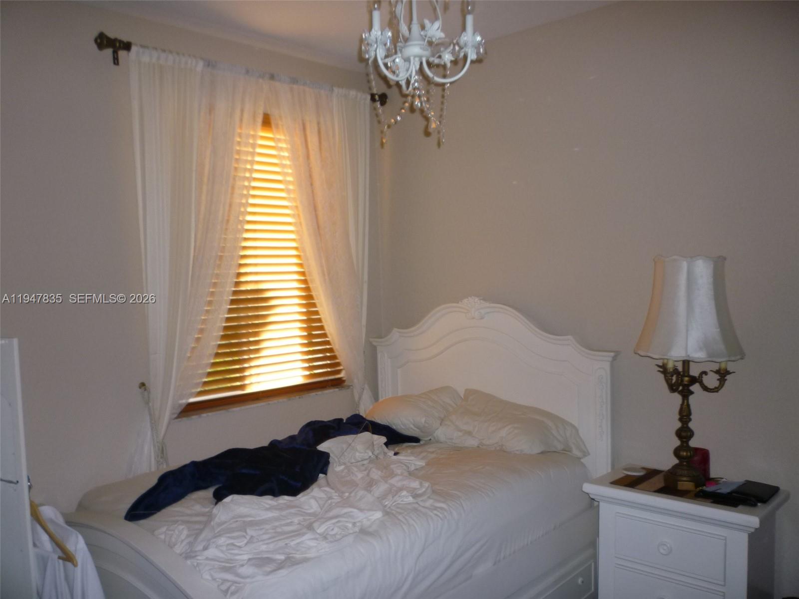 644 Conservation Drive Weston, FL 33327 - Photo 20 of 24 a bedroom with a bed and a window