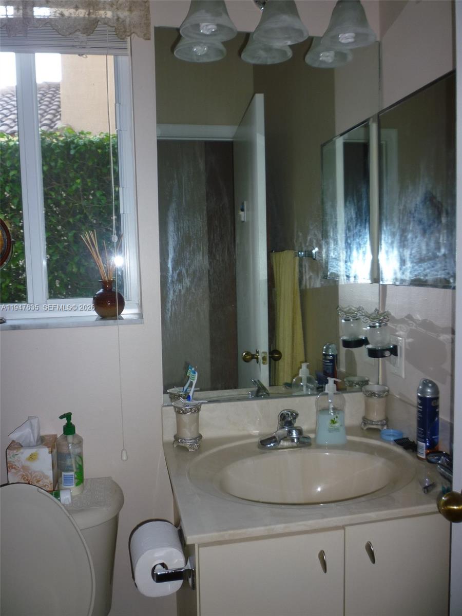 644 Conservation Drive Weston, FL 33327 - Photo 22 of 24 a bathroom with a sink and a mirror