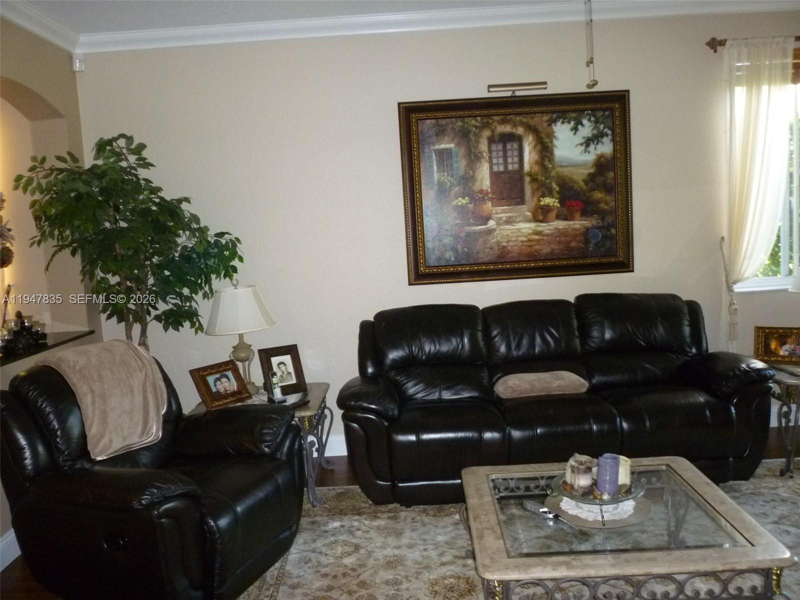 644 Conservation Drive Weston, FL 33327 - Photo 6 of 24 a living room with furniture flowerpot and wooden floor