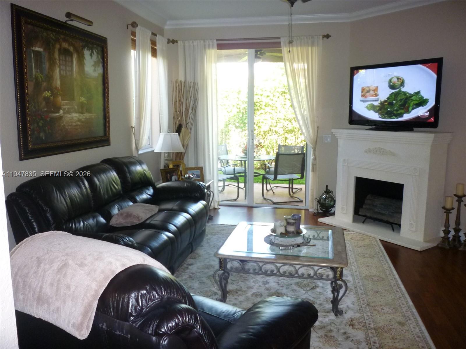 644 Conservation Drive Weston, FL 33327 - Photo 7 of 24 a living room with furniture a large window and a fireplace