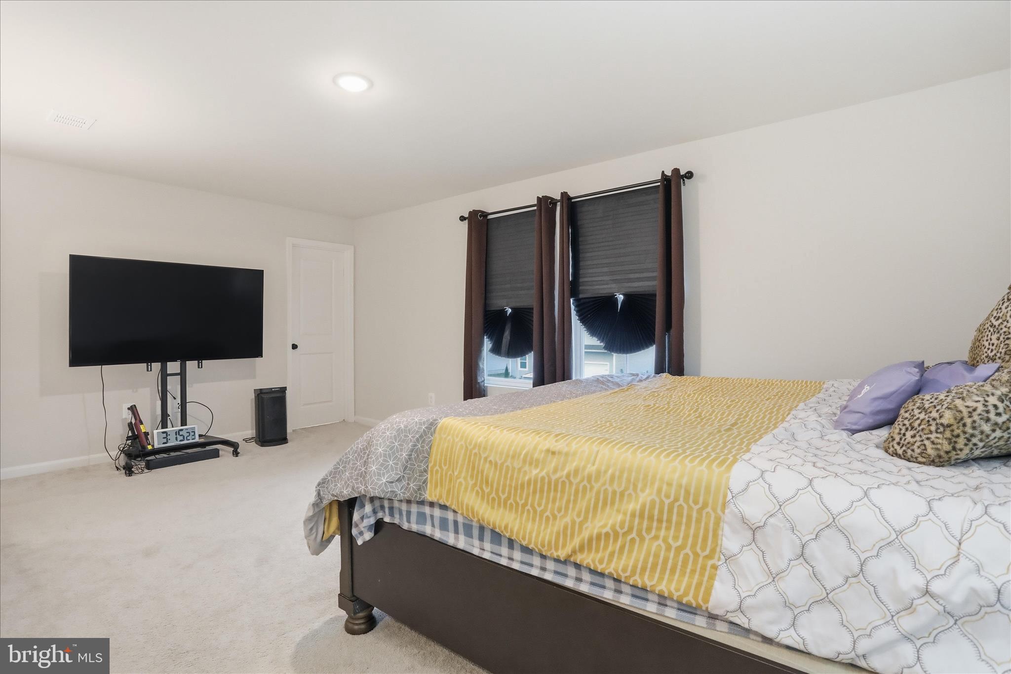 76 Diving Scaup Road Hedgesville, WV 25427 - Photo 18 of 48 a bedroom with a bed and a flat screen tv