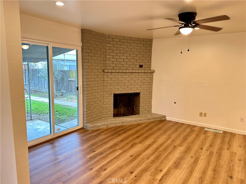 1231 7th Street Livingston, CA 95334 - Photo 11 of 39 a view of an empty room with a fireplace and a window