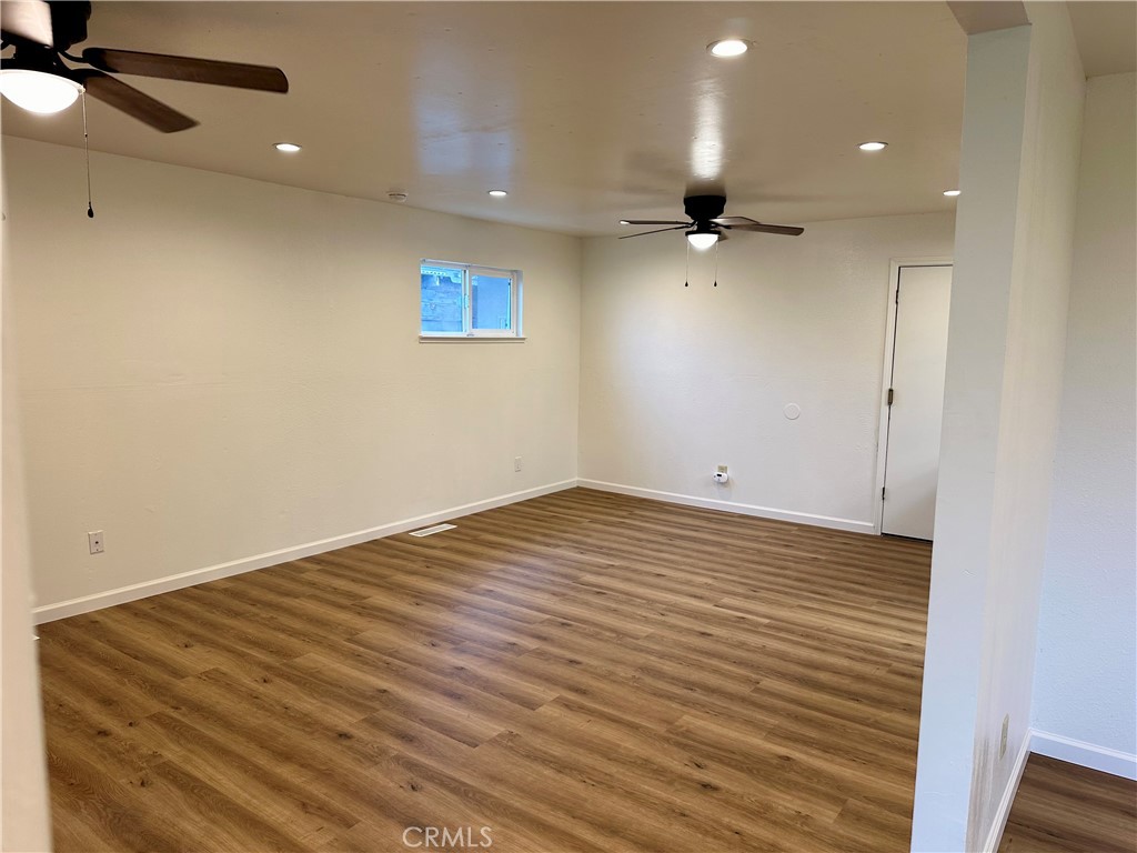 1231 7th Street Livingston, CA 95334 - Photo 13 of 39 an empty room with wooden floor a ceiling fan and wooden floor
