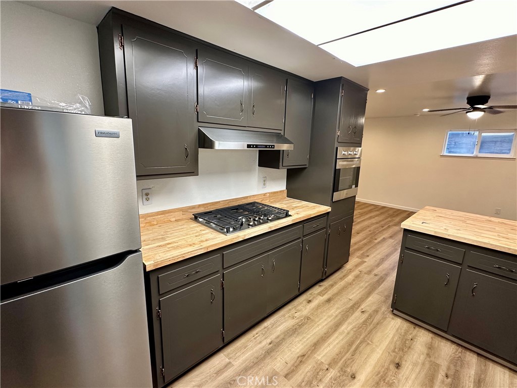 1231 7th Street Livingston, CA 95334 - Photo 17 of 39 a kitchen with a sink a refrigerator and cabinets