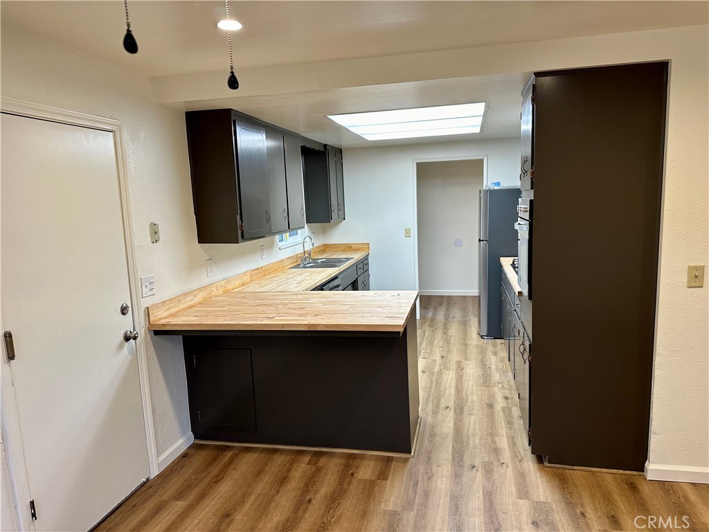 1231 7th Street Livingston, CA 95334 - Photo 20 of 39 a kitchen with a sink and a refrigerator