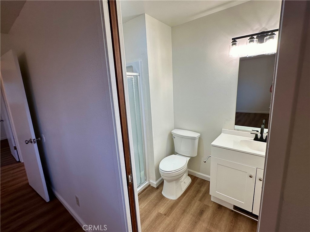 1231 7th Street Livingston, CA 95334 - Photo 29 of 39 a bathroom with a toilet a sink a vanity and mirror