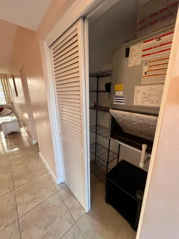 a hallway with a window and couch