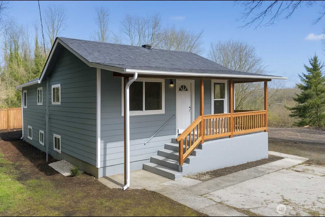 4110 South 114th Street Tukwila, WA 98168 - Photo 1 of 10 a view of a house with a yard and wooden fence