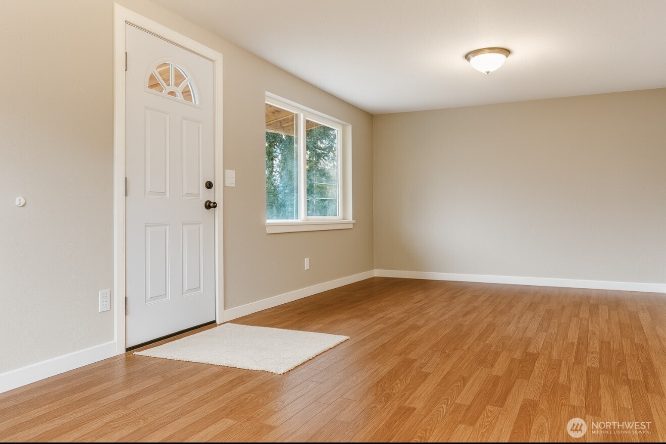 4110 South 114th Street Tukwila, WA 98168 - Photo 3 of 10 an empty room with wooden floor and windows