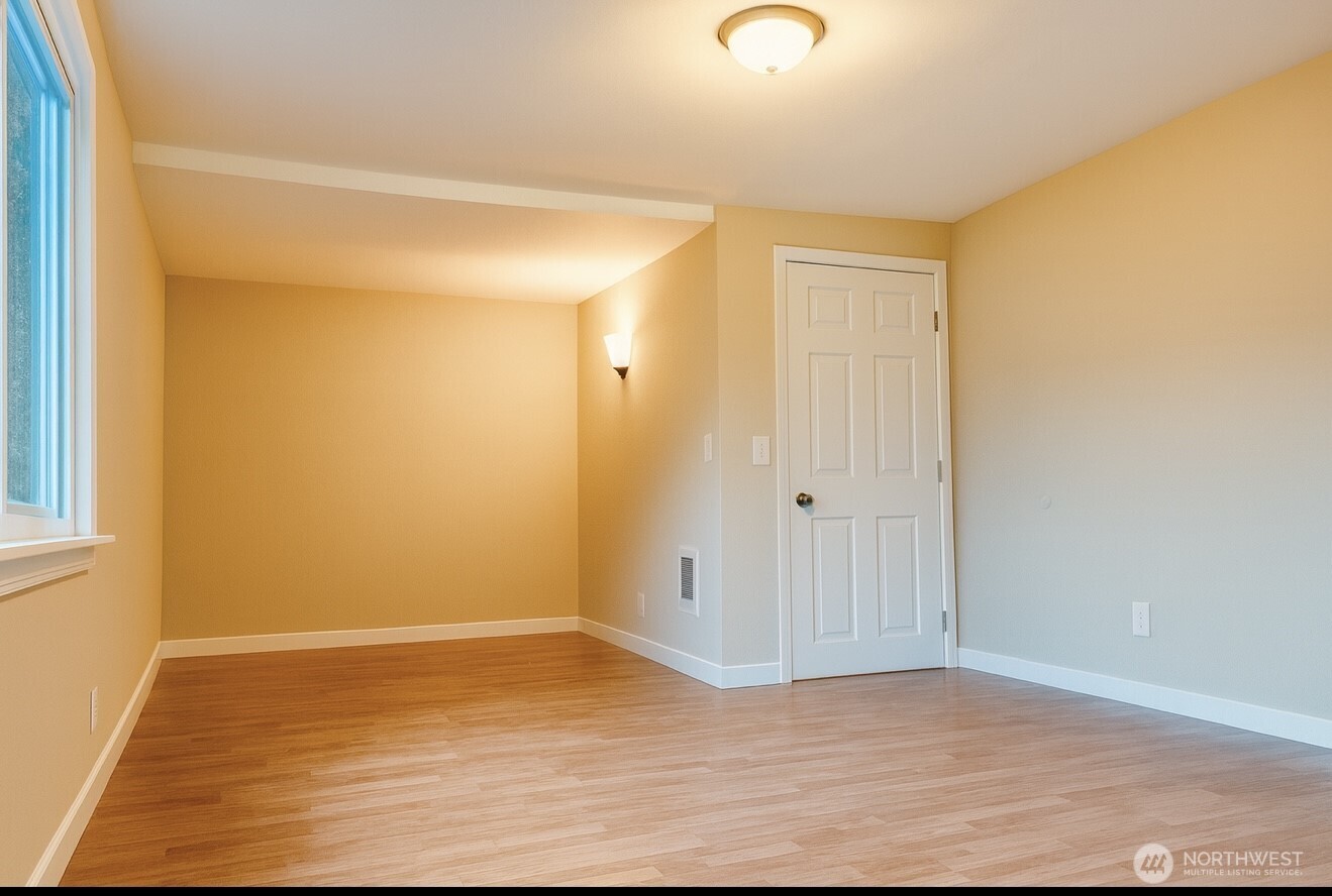 4110 South 114th Street Tukwila, WA 98168 - Photo 4 of 10 a view of an empty room with wooden floor