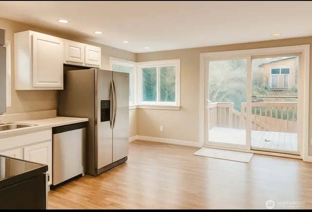a kitchen with stainless steel appliances granite countertop a refrigerator and a stove