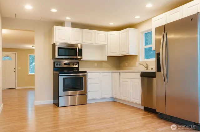 a kitchen with a refrigerator stove and microwave
