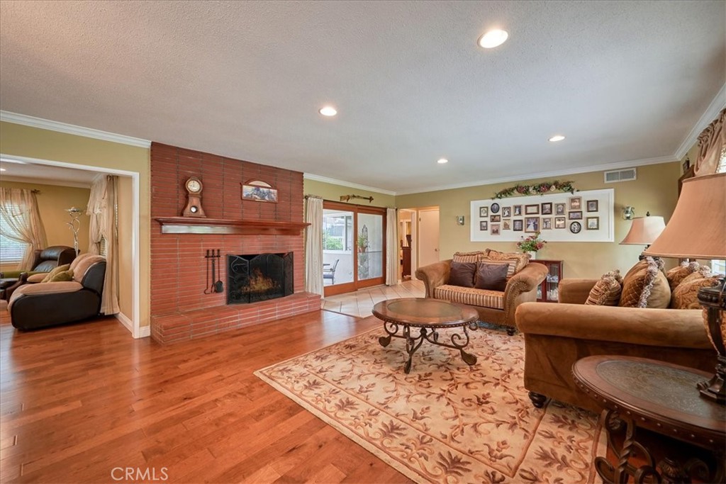 2221 Elsinore Road Riverside, CA 92506 - Photo 12 of 65 a living room with furniture and a fireplace