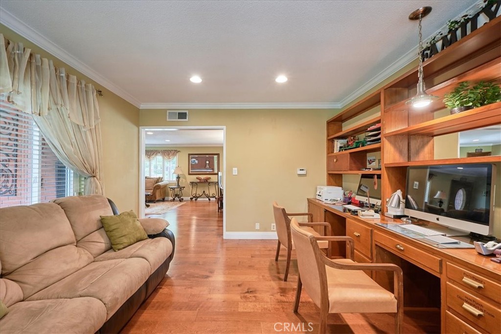 2221 Elsinore Road Riverside, CA 92506 - Photo 17 of 65 a living room with furniture a flat screen tv and a fireplace