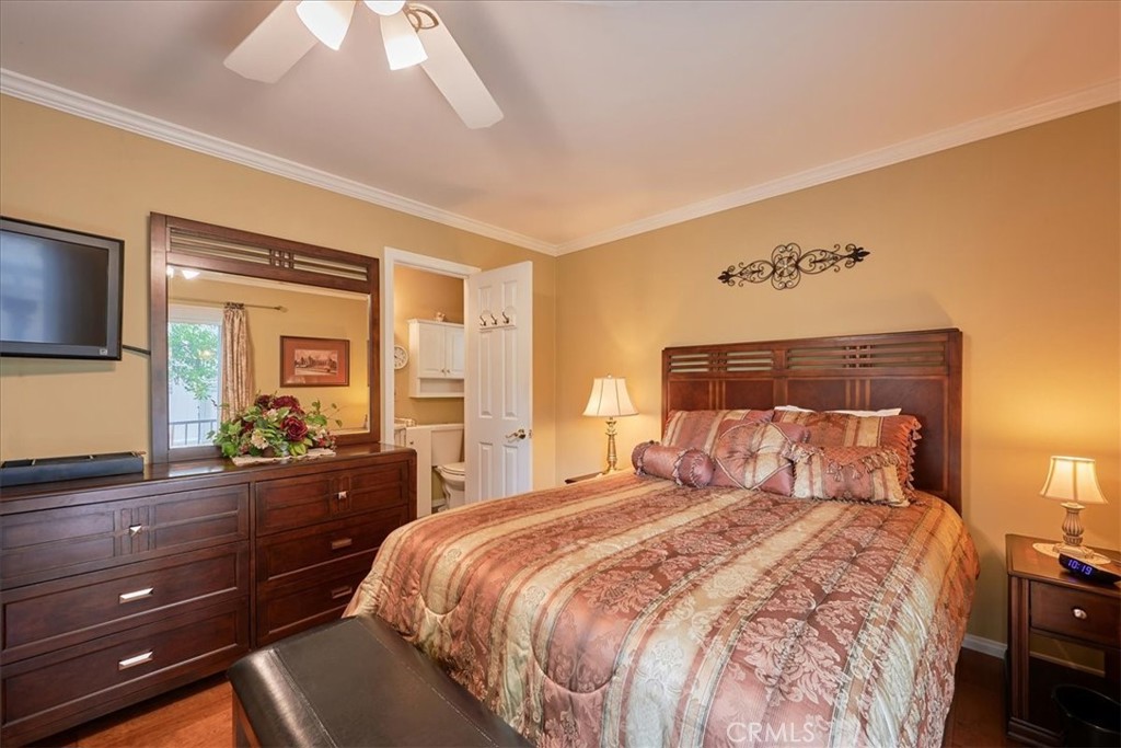 2221 Elsinore Road Riverside, CA 92506 - Photo 27 of 65 a bedroom with a bed and a flat tv screen on dresser