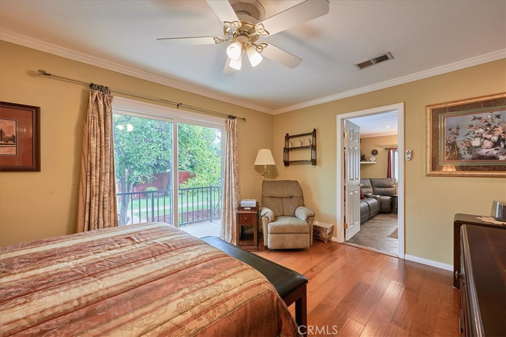 2221 Elsinore Road Riverside, CA 92506 - Photo 28 of 65 a bedroom with a bed couch and a large window