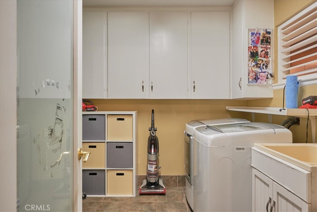 2221 Elsinore Road Riverside, CA 92506 - Photo 32 of 65 a view of cabinets a washer and dryer