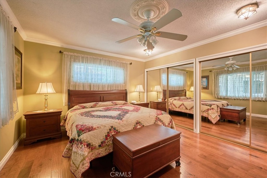 2221 Elsinore Road Riverside, CA 92506 - Photo 37 of 65 a bedroom with a bed and wooden floor