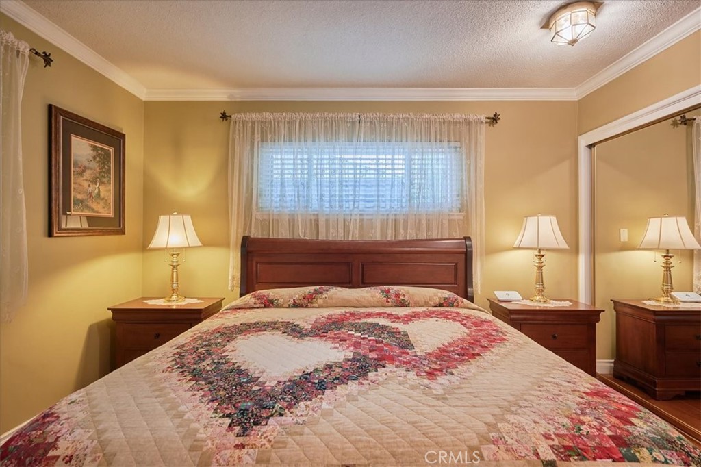 2221 Elsinore Road Riverside, CA 92506 - Photo 38 of 65 a bedroom with a bed and wooden floor