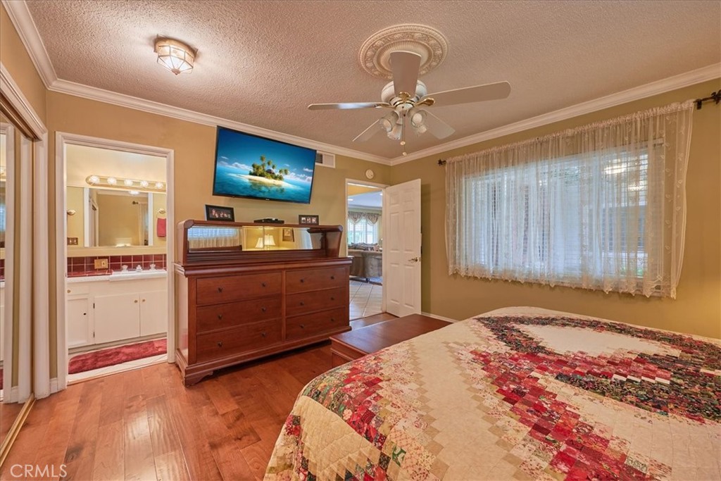 2221 Elsinore Road Riverside, CA 92506 - Photo 39 of 65 a bedroom with a bed and wooden floor