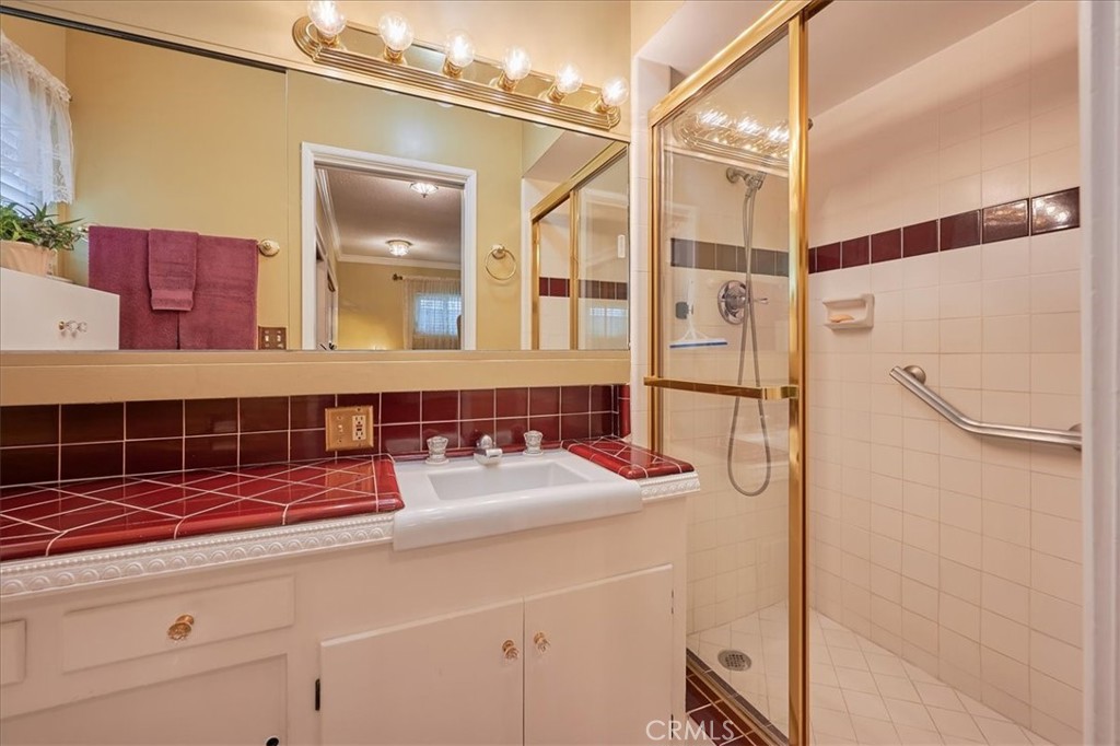 2221 Elsinore Road Riverside, CA 92506 - Photo 40 of 65 a bathroom with a sink and a mirror
