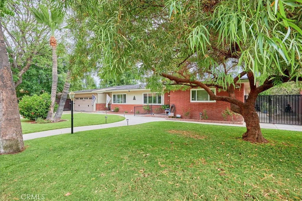 2221 Elsinore Road Riverside, CA 92506 - Photo 4 of 65 a house with green field in front of it