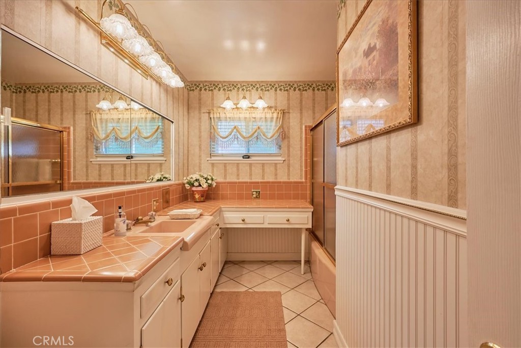 2221 Elsinore Road Riverside, CA 92506 - Photo 42 of 65 a bathroom with a double vanity sink and a large mirror