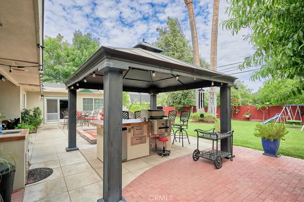 2221 Elsinore Road Riverside, CA 92506 - Photo 51 of 65 a view of a patio with a table and chairs under an umbrella
