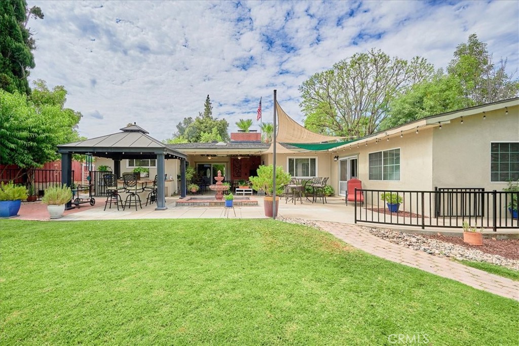 2221 Elsinore Road Riverside, CA 92506 - Photo 56 of 65 a view of a house with table and chairs under an umbrella