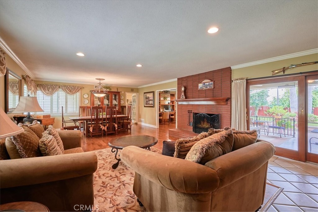 2221 Elsinore Road Riverside, CA 92506 - Photo 9 of 65 a living room with furniture a large window and a fireplace