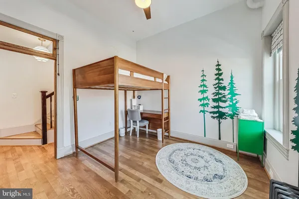 a bedroom with furniture and a window