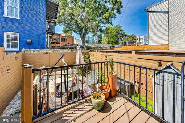 a balcony with chairs and wooden floor