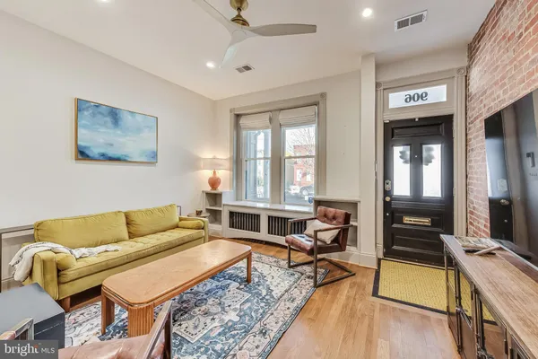 a living room with furniture and a wooden floor