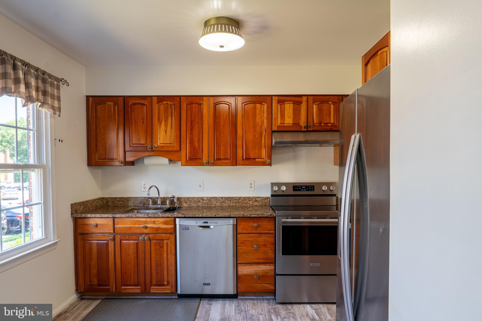 2913 Seminole Road Woodbridge, VA 22192 - Photo 12 of 34 a kitchen with wooden cabinets and a stove top oven