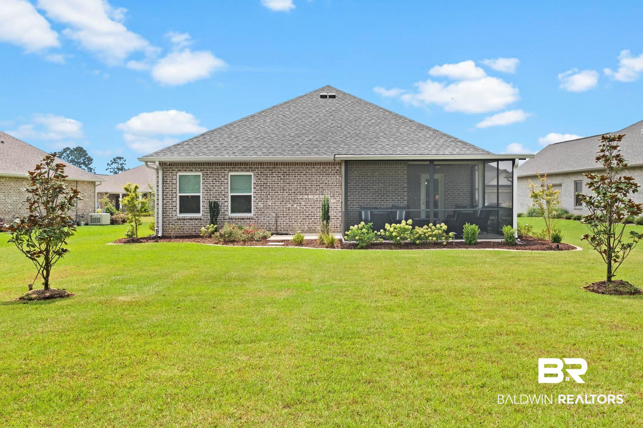 9815 Lakeview Drive Foley, AL 36535 - Photo 66 of 100 Back of house featuring a sunroom and a yard