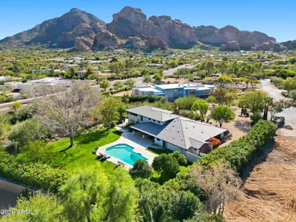 a view of a lush green hillside and houses