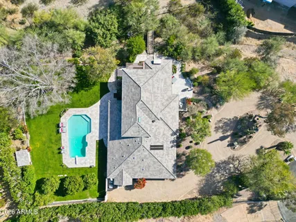 an aerial view of a house with outdoor space and a lake view