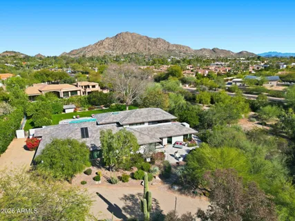 an aerial view of residential houses with outdoor space and street view