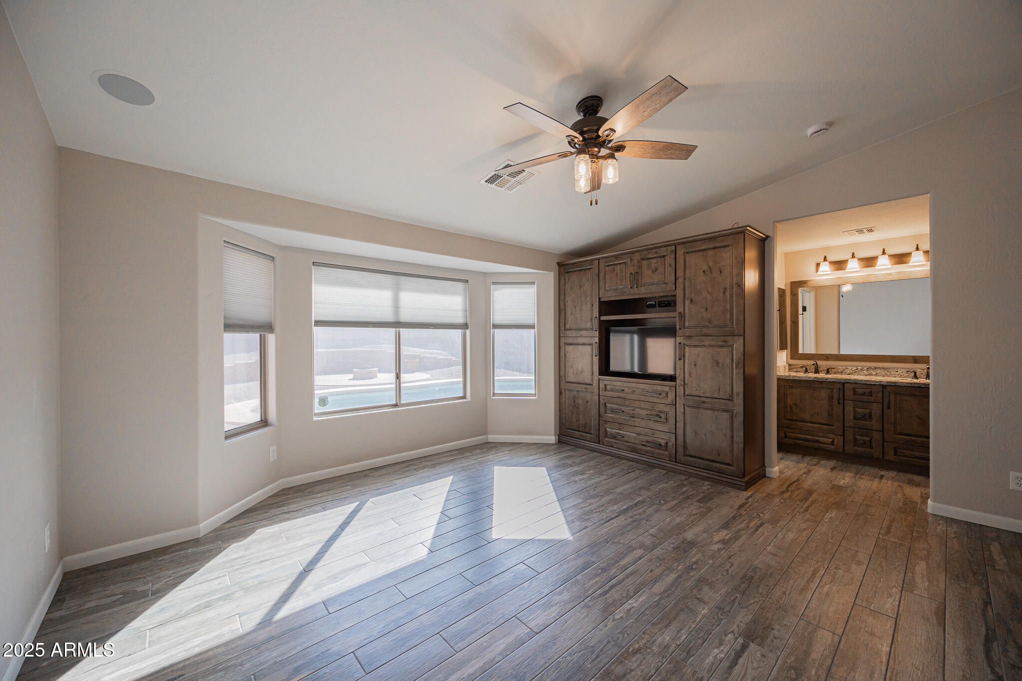 1633 East Beautiful Lane Phoenix, AZ 85042 - Photo 13 of 27 a view of a livingroom with a ceiling fan and wooden floor