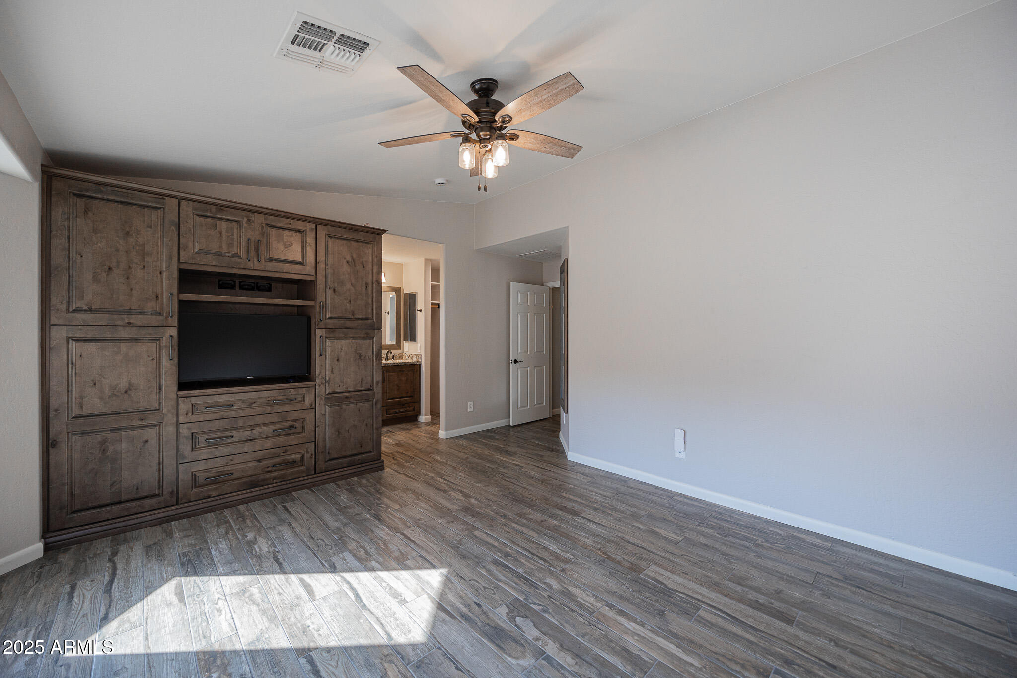 1633 East Beautiful Lane Phoenix, AZ 85042 - Photo 14 of 27 wooden floor in an empty room with a fireplace