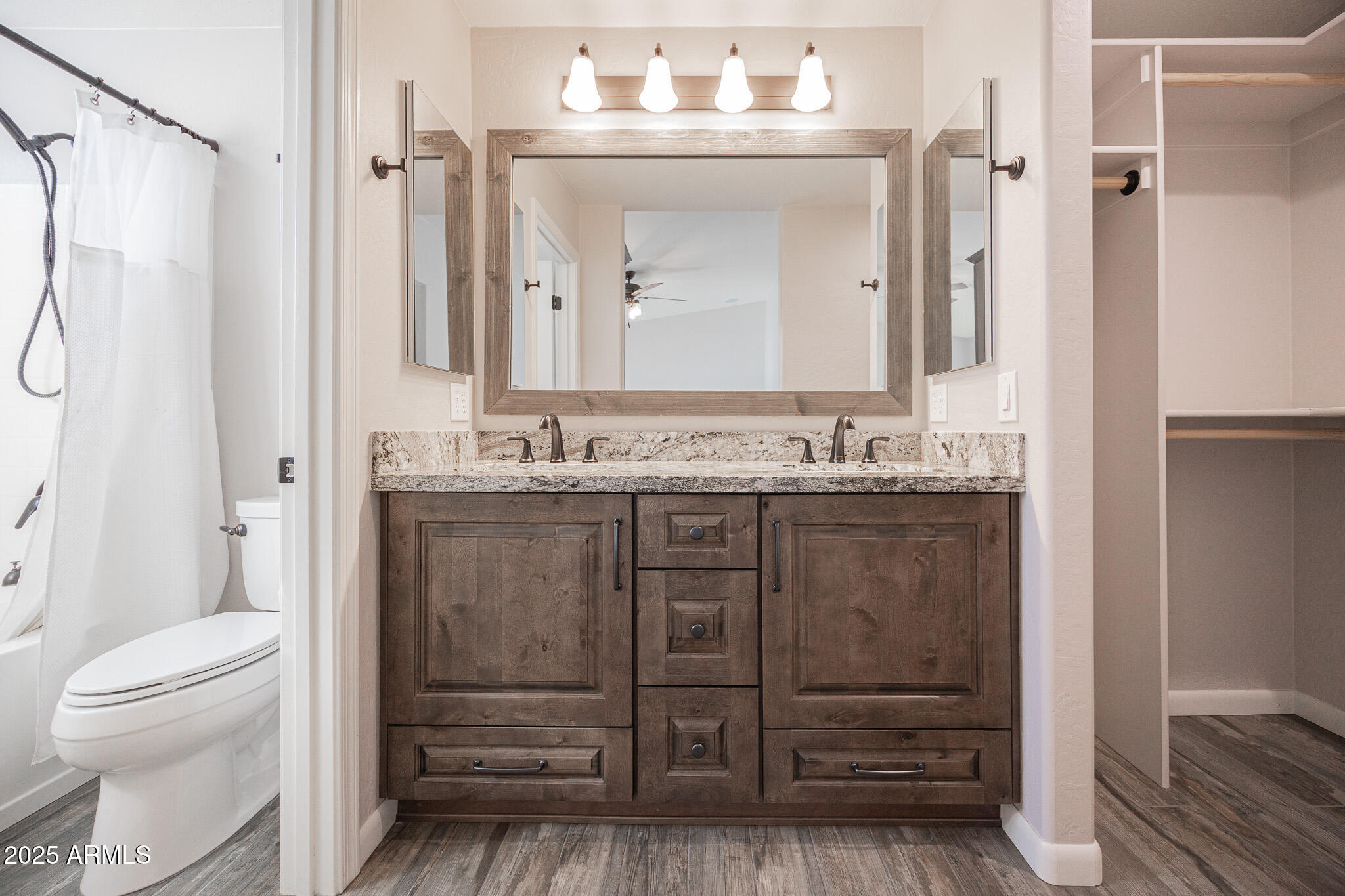 1633 East Beautiful Lane Phoenix, AZ 85042 - Photo 15 of 27 a bathroom with a granite countertop sink toilet a mirror a vanity and shower