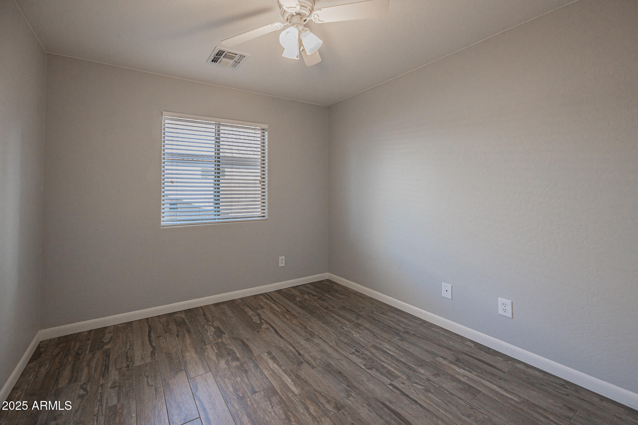 1633 East Beautiful Lane Phoenix, AZ 85042 - Photo 18 of 27 wooden floor in an empty room with a window